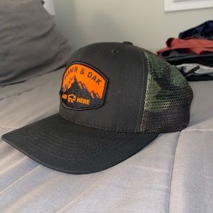 Banner & Oak Camo/ Black Trucker Hat